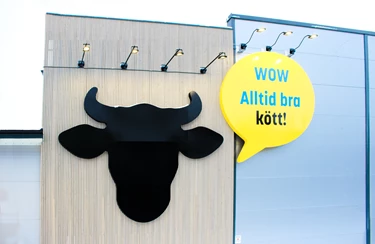 Eurocash Eda Fasad långsida med en skylt som visar svart tjurhuvud-symbol och pratbubbla som läser "WOW alltid bra kött!".